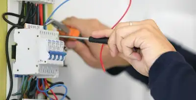 Electrician installing and adjusting circuit breakers in an electrical panel in Allentown, PA