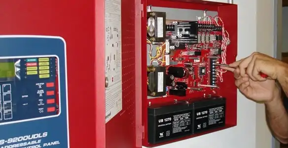 fire alarm installation service showing technician configuring fire alarm control panel in Allentown, PA
