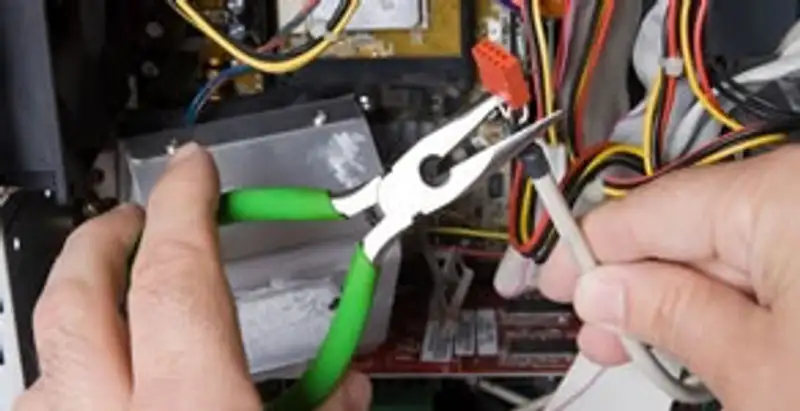 Licensed electrical contractor performing electrical repair with tools in Northampton, PA