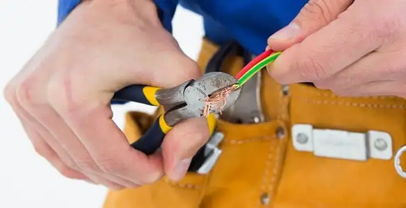 licensed electrician securing electrical wiring with professional tools during service work in Allentown, PA