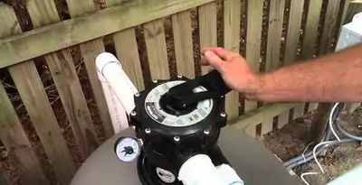 pool pumps service showing professional adjustment of pool pump control system in Allentown, PA