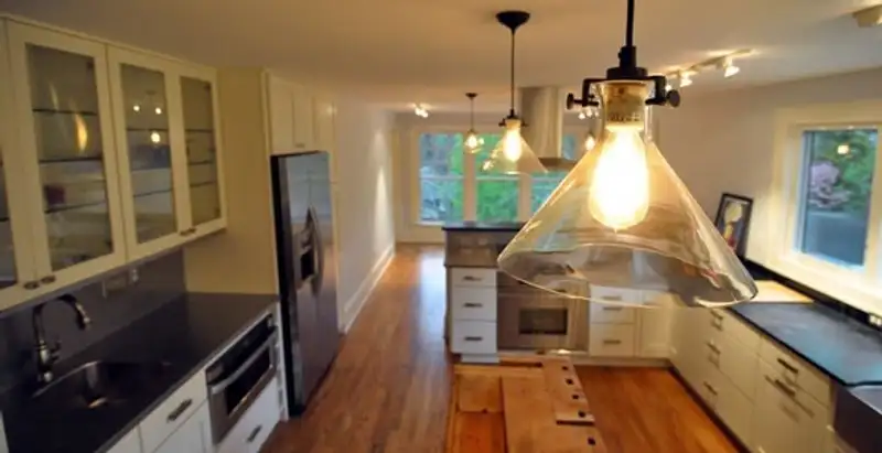 Residential electrician installing modern indoor light fixture in a home in Allentown, PA
